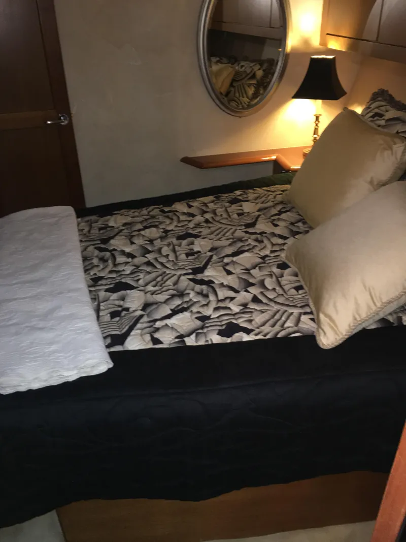Slide: The Image of Cozy bedroom in 2001 Ocean Yachts 56 Super Sport with patterned bedding and ambient lighting. - 37