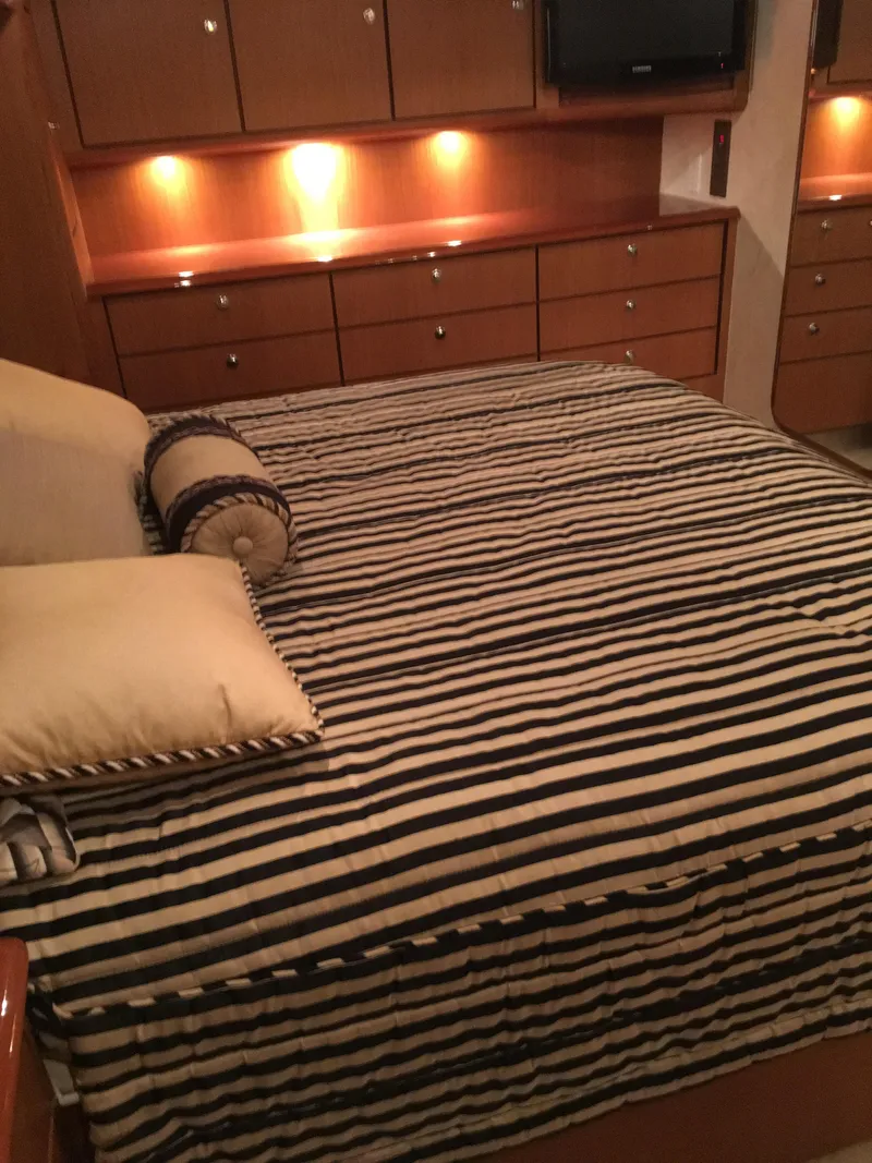 Slide: The Image of Luxurious bedroom interior of 2001 Ocean Yachts 56 Super Sport with striped bedding. - 40