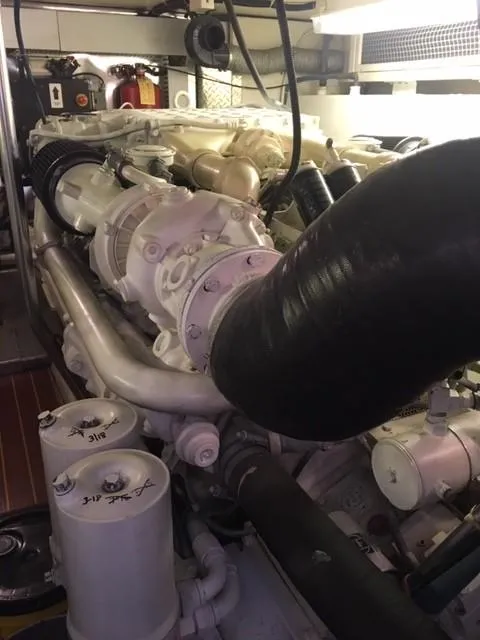 Slide: The Image of Engine room of 2001 Ocean Yachts 56 Super Sport, showcasing detailed machinery components. - 41