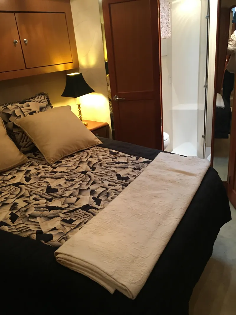 Slide: The Image of Luxurious bedroom in 2001 Ocean Yachts 56 Super Sport with elegant decor and ensuite bathroom. - 22