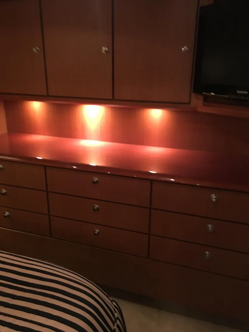 Slide: The Image of 2001 Ocean Yachts 56 Super Sport interior with wooden cabinets and ambient lighting. - 30