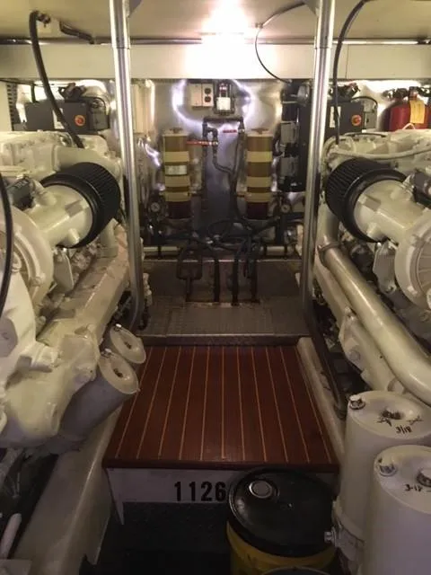 Slide: The Image of Engine room of 2001 Ocean Yachts 56 Super Sport, showcasing dual engines and equipment. - 43