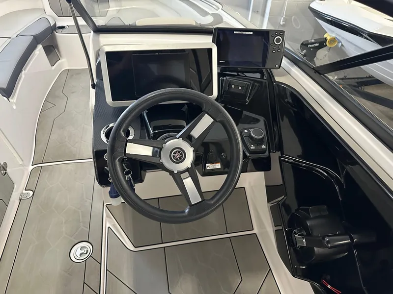 Slide: The Image of 2021 Yamaha Boats AR250 cockpit with steering wheel and navigation controls. - 10