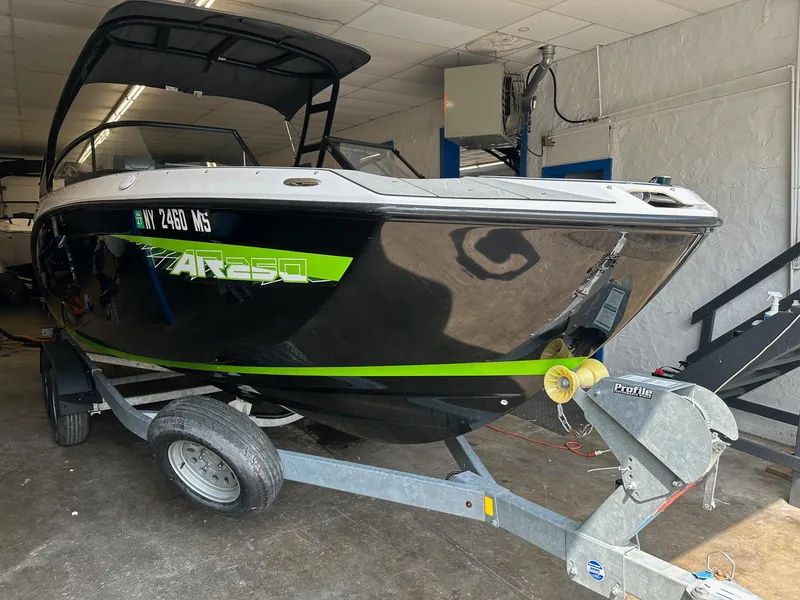 Slide: The Image of 2021 Yamaha Boats AR250 on trailer in indoor storage facility. - 2