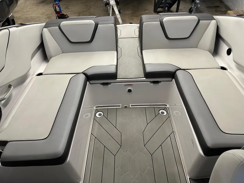 Slide: The Image of 2021 Yamaha Boats AR250 interior seating with gray and white upholstery. - 6