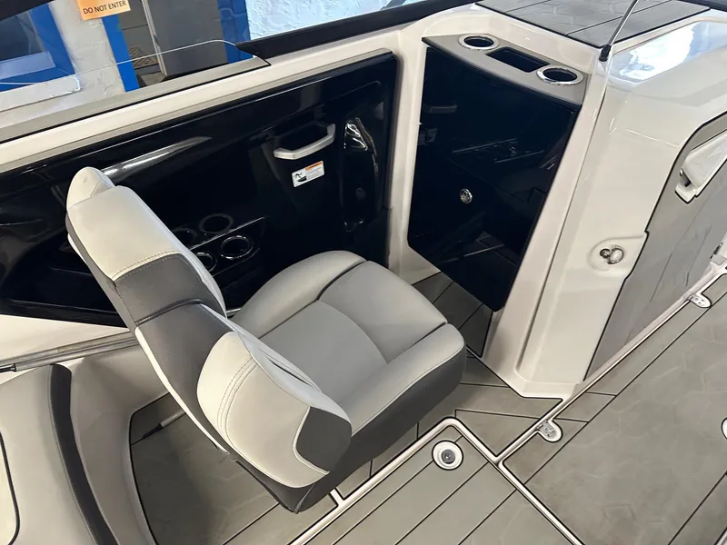 Slide: The Image of 2021 Yamaha Boats AR250 interior with gray seating and cup holders. - 8