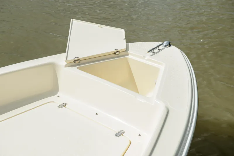 Slide: The Image of Scout 175 Sport Dorado 2026 with open storage compartment on water. - 16