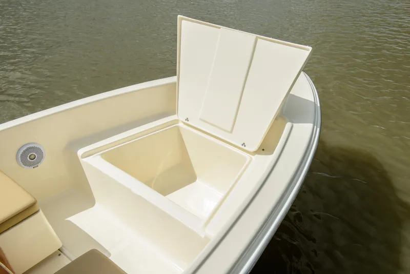 Slide: The Image of Scout 175 Sport Dorado 2026 with open storage compartment on water. - 17