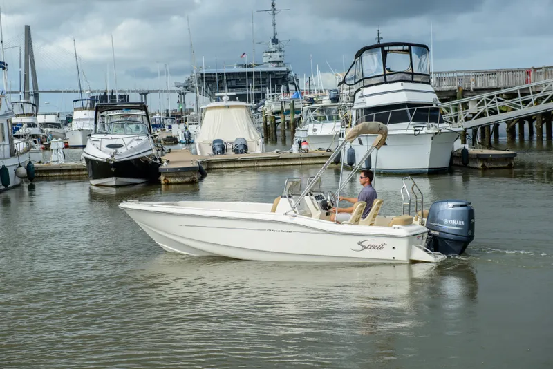 Slide: The Image of Scout 175 Sport Dorado 2026 in harbor with yachts in background. - 19