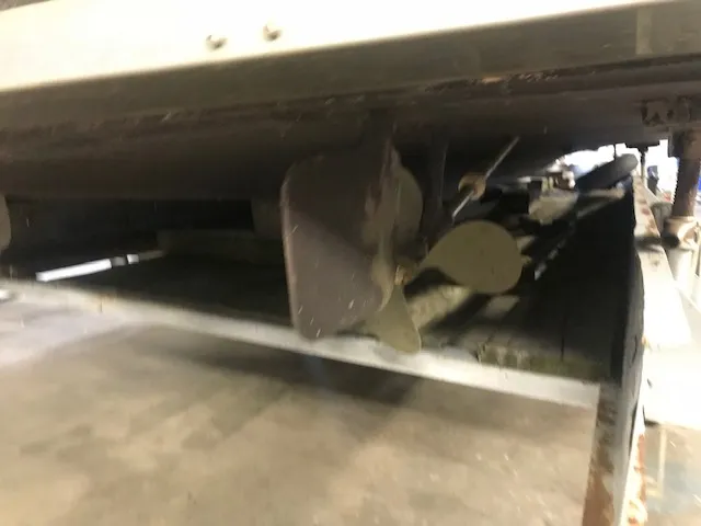 Slide: The Image of 1969 Chris-Craft Commander Sedan propeller and rudder in a storage facility. - 10