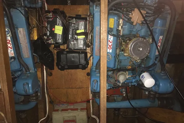 Slide: The Image of Engine compartment of a 1969 Chris-Craft Commander Sedan, featuring dual blue engines and batteries. - 12