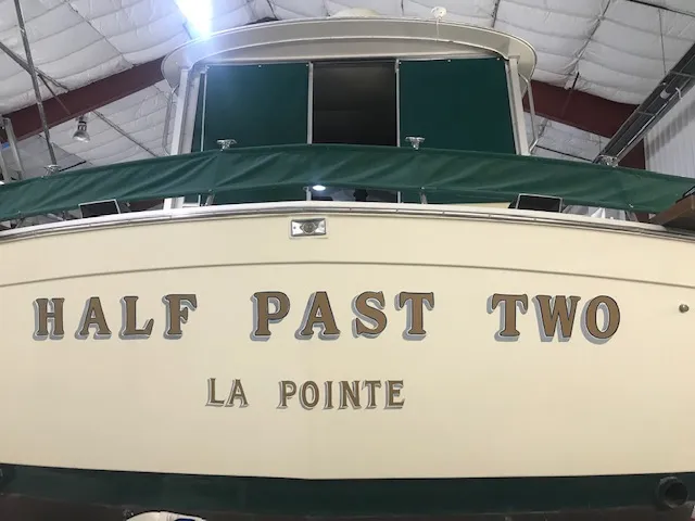 Slide: The Image of 1969 Chris-Craft Commander Sedan boat named "Half Past Two" in a storage facility. - 5