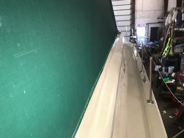 Slide: The Image of 1969 Chris-Craft Commander Sedan in a workshop, featuring a green canopy. - 7