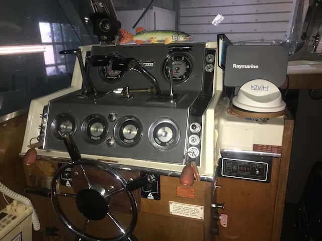 Slide: The Image of 1969 Chris-Craft Commander Sedan dashboard with steering wheel and navigation equipment. - 8