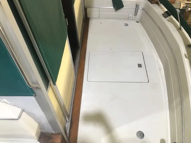 Slide: The Image of 1969 Chris-Craft Commander Sedan deck with green accents and storage hatch. - 9