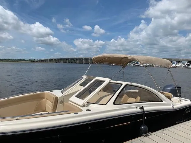 Slide: The Image of Scout 240 Dorado 2026 boat docked with bridge in background. - 40