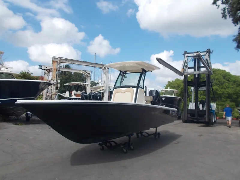 The Image of 2025 Scout 251XSS boat on a lot under blue skies. - 0