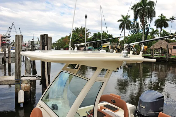 Slide: The Image of Scout 251XSS 2025 boat docked with palm trees in background. - 3