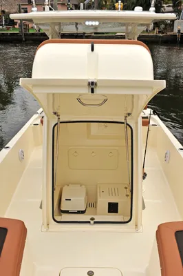 Slide: The Image of Scout 251XSS 2025 boat with open storage compartment by the water. - 7