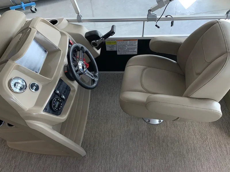 Slide: The Image of 2024 Starcraft LX20 F boat interior with captain's chair and control console. - 14