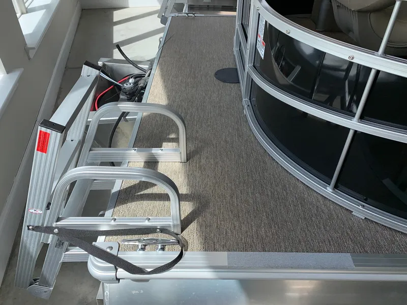 Slide: The Image of 2024 Starcraft LX20 F pontoon boat deck with ladder and railing. - 16