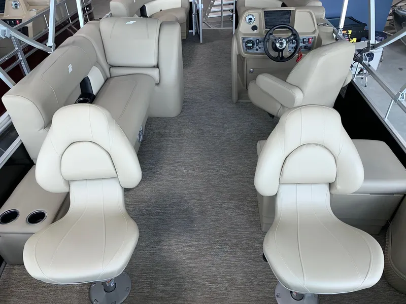 Slide: The Image of 2024 Starcraft LX20 F boat interior with beige seating and modern dashboard. - 4
