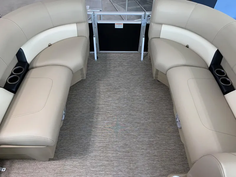 Slide: The Image of 2024 Starcraft LX20 F boat interior with beige seating and cup holders. - 7
