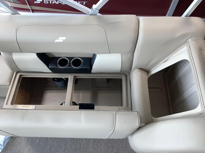 Slide: The Image of 2024 Starcraft LX20 F boat interior with beige seating and cup holders. - 8