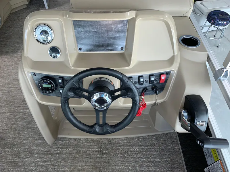 Slide: The Image of 2024 Starcraft LX20 F boat dashboard with steering wheel and control panel. - 11