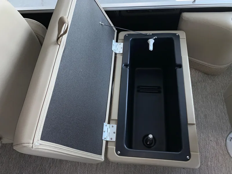 Slide: The Image of 2024 Starcraft LX20 F boat storage compartment with open lid. - 12