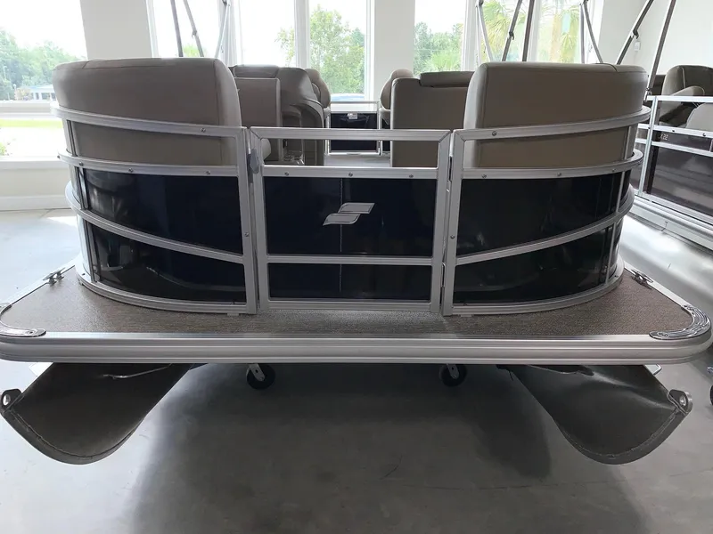Slide: The Image of 2024 Starcraft LX20 F pontoon boat rear view in showroom. - 2