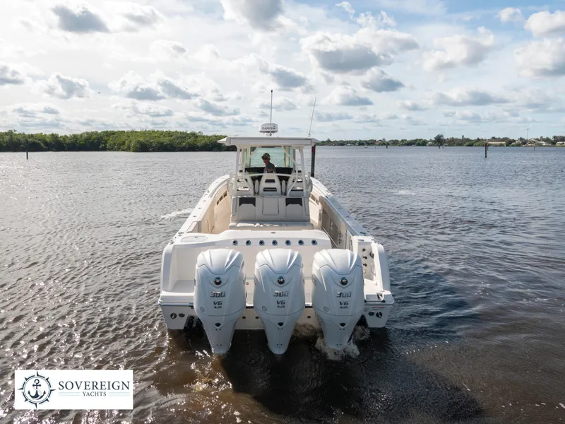 Slide: The Image of 2024 Sailfish 360 CC boat with triple outboard engines on the water. - 24