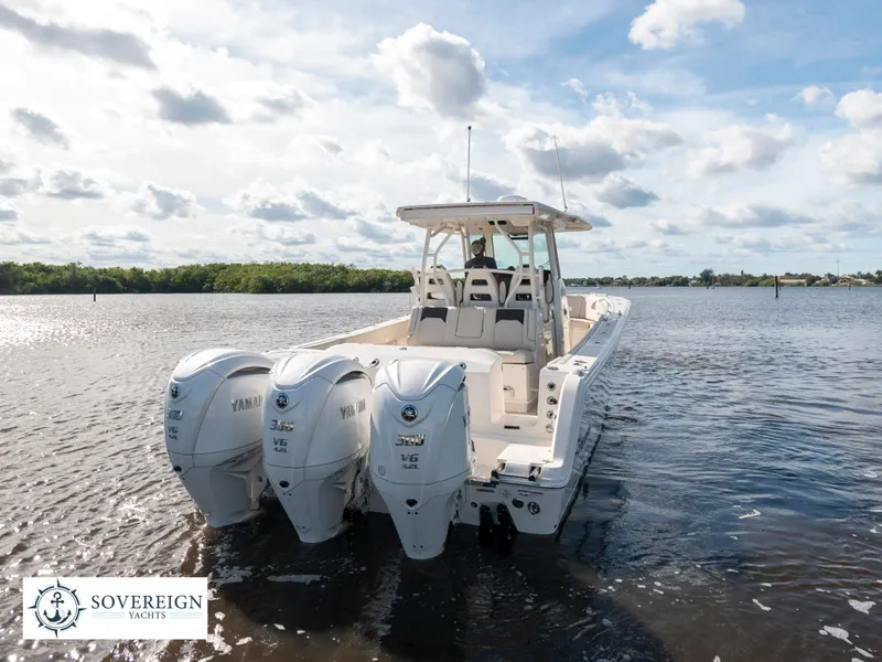 Slide: The Image of 2024 Sailfish 360 CC boat with triple Yamaha engines on calm water. - 25