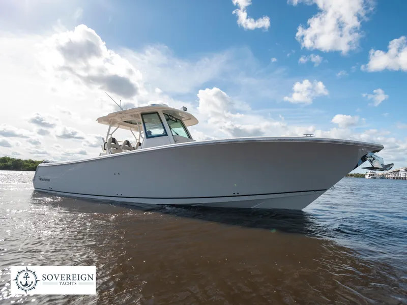 Slide: The Image of 2024 Sailfish 360 CC boat on water, Sovereign Yachts logo, sunny day with clouds. - 29