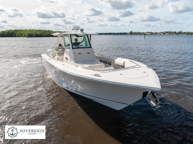 Slide: The Image of 2024 Sailfish 360 CC boat cruising on a calm river. - 31