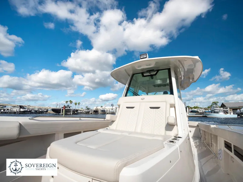 Slide: The Image of 2024 Sailfish 360 CC boat docked at a marina under a blue sky. - 37
