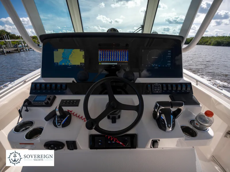 Slide: The Image of 2024 Sailfish 360 CC boat helm with advanced navigation and control systems. - 40