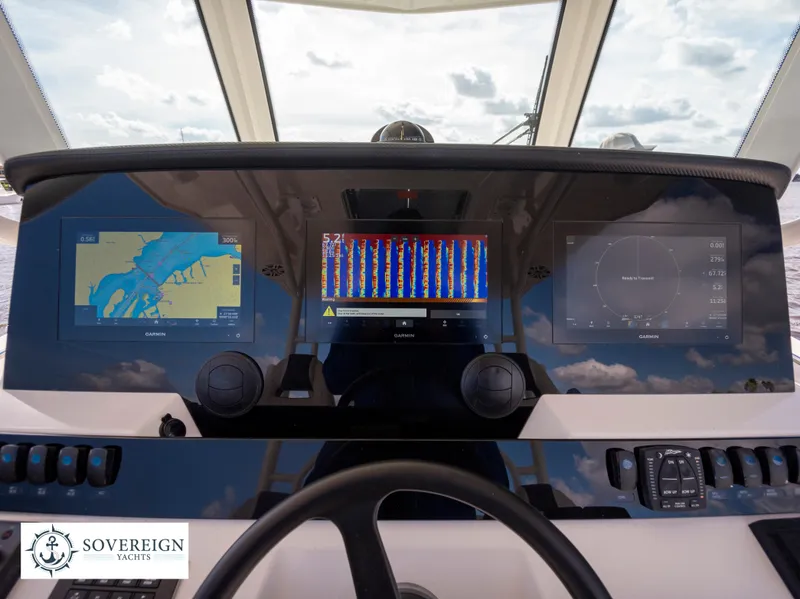 Slide: The Image of 2024 Sailfish 360 CC helm with advanced navigation displays and controls. Sovereign Yachts logo visible. - 42