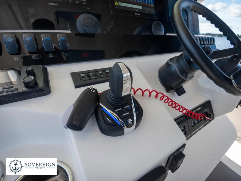 Slide: The Image of Control panel of 2024 Sailfish 360 CC boat with joystick and steering wheel. - 45