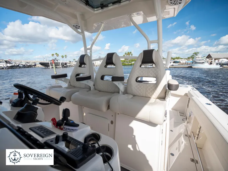 Slide: The Image of 2024 Sailfish 360 CC boat interior with luxurious seating and waterfront view. - 49