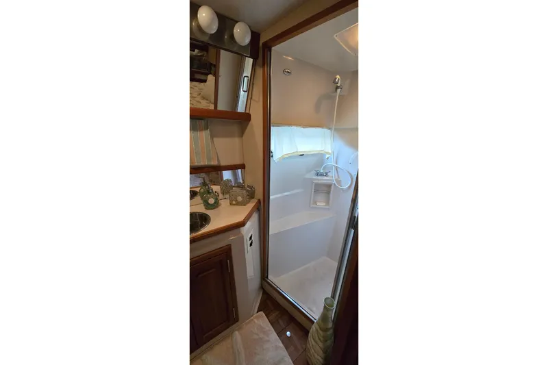 Slide: The Image of 1989 Carver 42 Aft Cabin Motor Yacht bathroom with shower and vanity. - 12