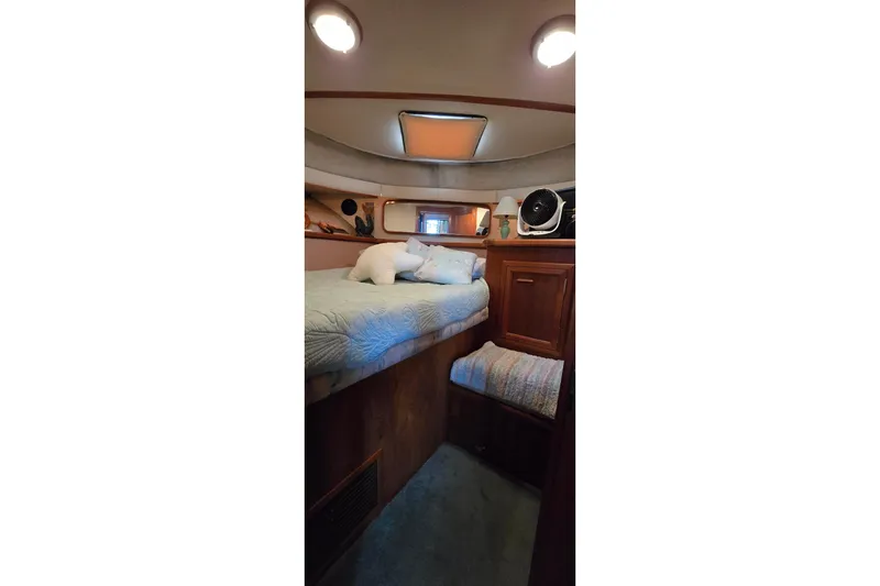 Slide: The Image of Cozy cabin interior of 1989 Carver 42 Aft Cabin Motor Yacht with bed and fan. - 13
