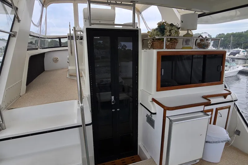 Slide: The Image of 1989 Carver 42 Aft Cabin Motor Yacht interior with cabinets and seating area. - 2