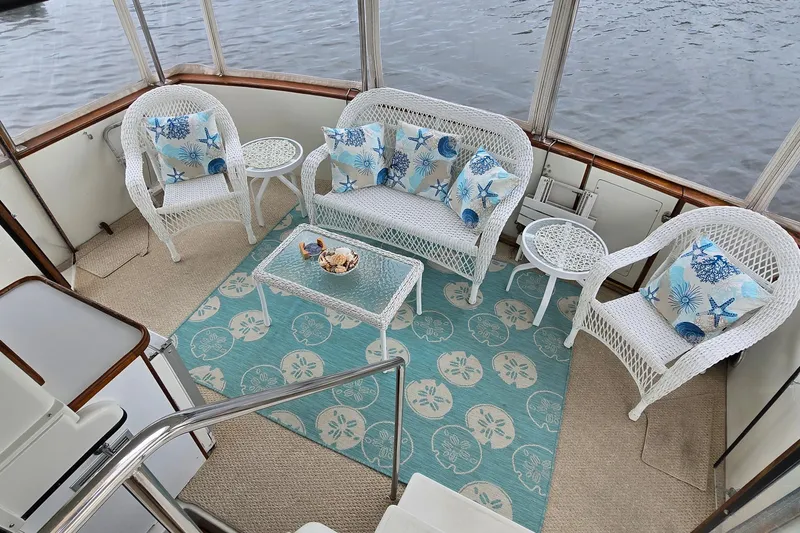 Slide: The Image of 1989 Carver 42 Aft Cabin Motor Yacht with elegant wicker seating and nautical decor. - 3