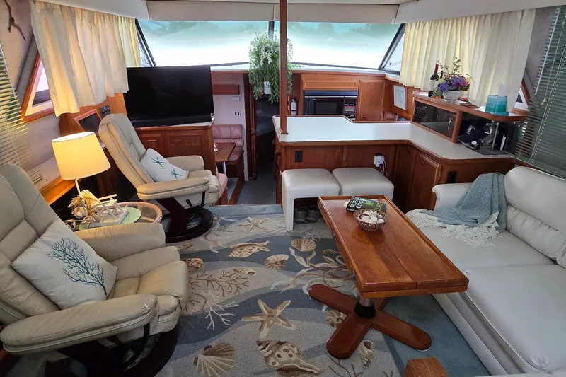 Slide: The Image of Interior of 1989 Carver 42 Aft Cabin Motor Yacht with cozy seating and nautical decor. - 4