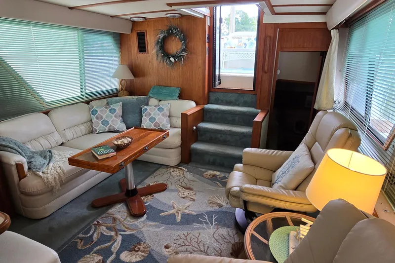 Slide: The Image of Cozy interior of 1989 Carver 42 Aft Cabin Motor Yacht with plush seating and nautical decor. - 5
