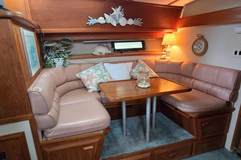 Slide: The Image of Cozy dining nook in 1989 Carver 42 Aft Cabin Motor Yacht with plush seating and nautical decor. - 8