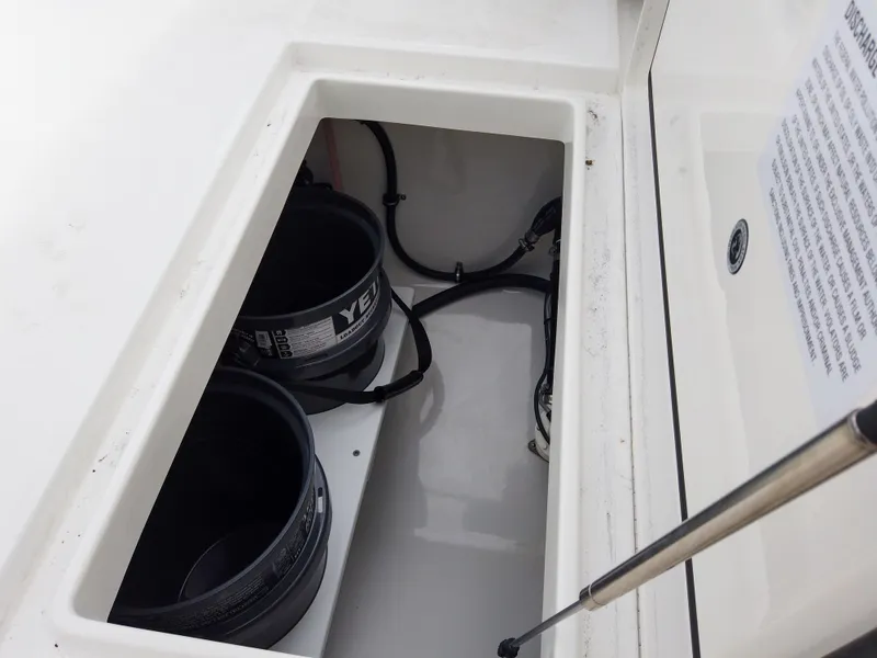 Slide: The Image of Storage compartment of 2023 Regulator 28 boat with Yeti buckets. - 13