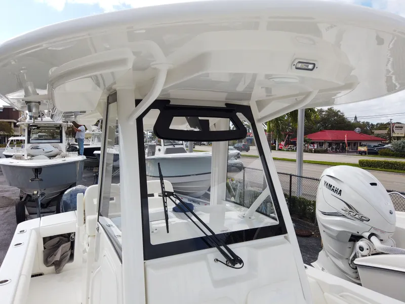 Slide: The Image of 2023 Regulator 28 boat with Yamaha outboard motor, center console, and T-top. - 17