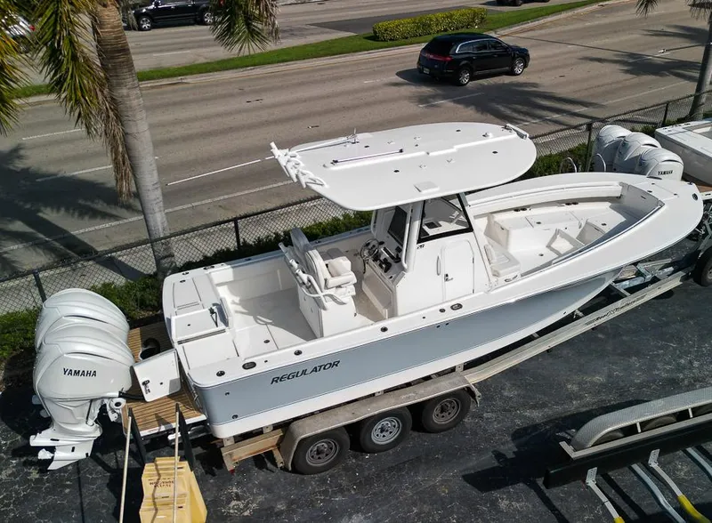 Slide: The Image of 2023 Regulator 28 boat on trailer with twin Yamaha engines. - 2